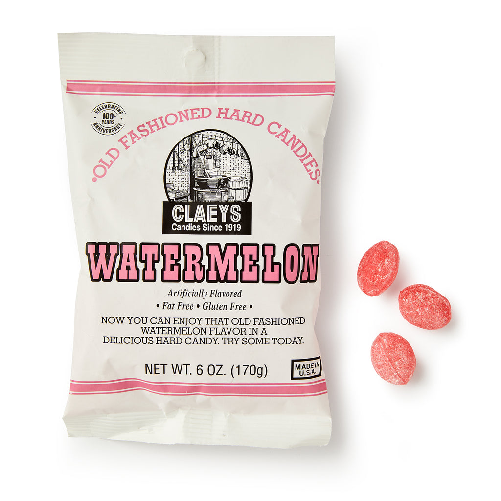 A white bag of Watermelon Old Fashioned Hard Candies is shown with three pink oval candies beside it. The bag has red and black text and a candy kettle illustration, highlighting these classic watermelon-flavored hard candies.