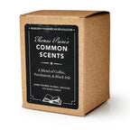 A brown box labeled "Common Scents Candle" from the Museum of the American Revolution describes a hand-poured soy blend candle with notes of coffee, parchment, and black ink.