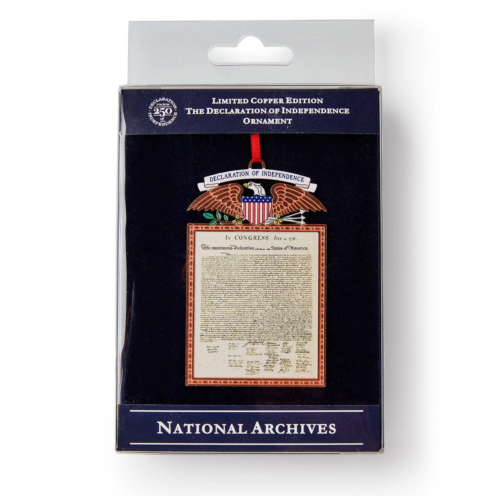 The Declaration Copper Ornament features the Declaration of Independence, an eagle with a shield, and is labeled “Limited Copper Edition” and “National Archives.” It hangs on a red ribbon inside its packaging.