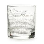 The Declaration of Independence Whiskey Glass features etched text like “July 4, 1776” and “United States of America” in decorative script—a unique patriotic gift, shown against a white background.