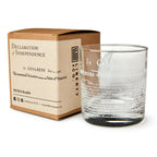 The Declaration of Independence Whiskey Glass sits beside a brown box labeled "Declaration of Independence and Liberty," creating a unique patriotic gift with branded packaging and historical details.