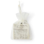 A small white mesh gift bag containing the Declaration of Independence Ornament—a stone ornamment printed with the historic text and signatures.
