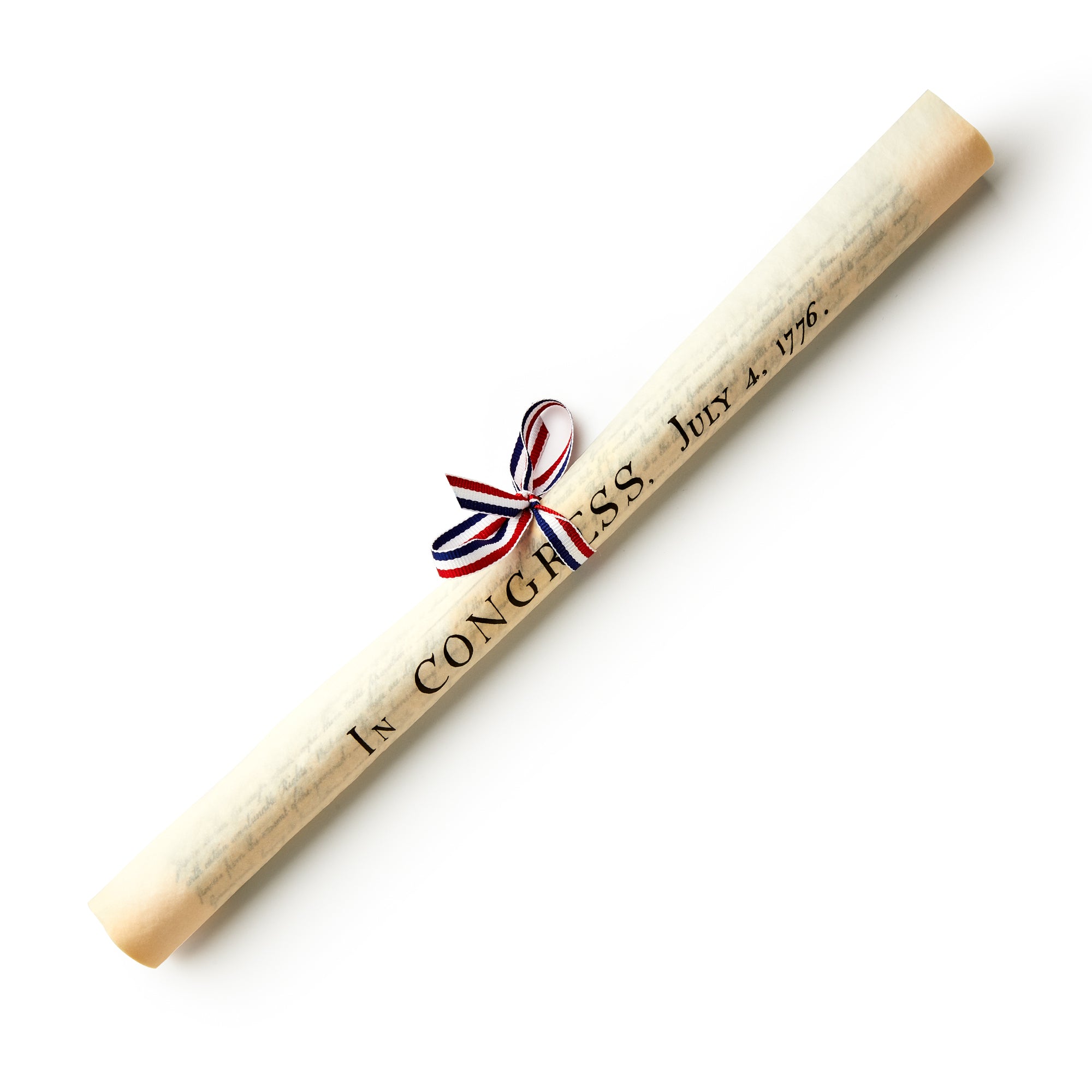The Declaration of Independence Small Replica features a rolled aged parchment paper tied with a red, white, and blue ribbon and displays the printed words “In Congress, July 4, 1776”—a striking addition to any patriotic collection and a beautiful replica of the historic Declaration of Independence.