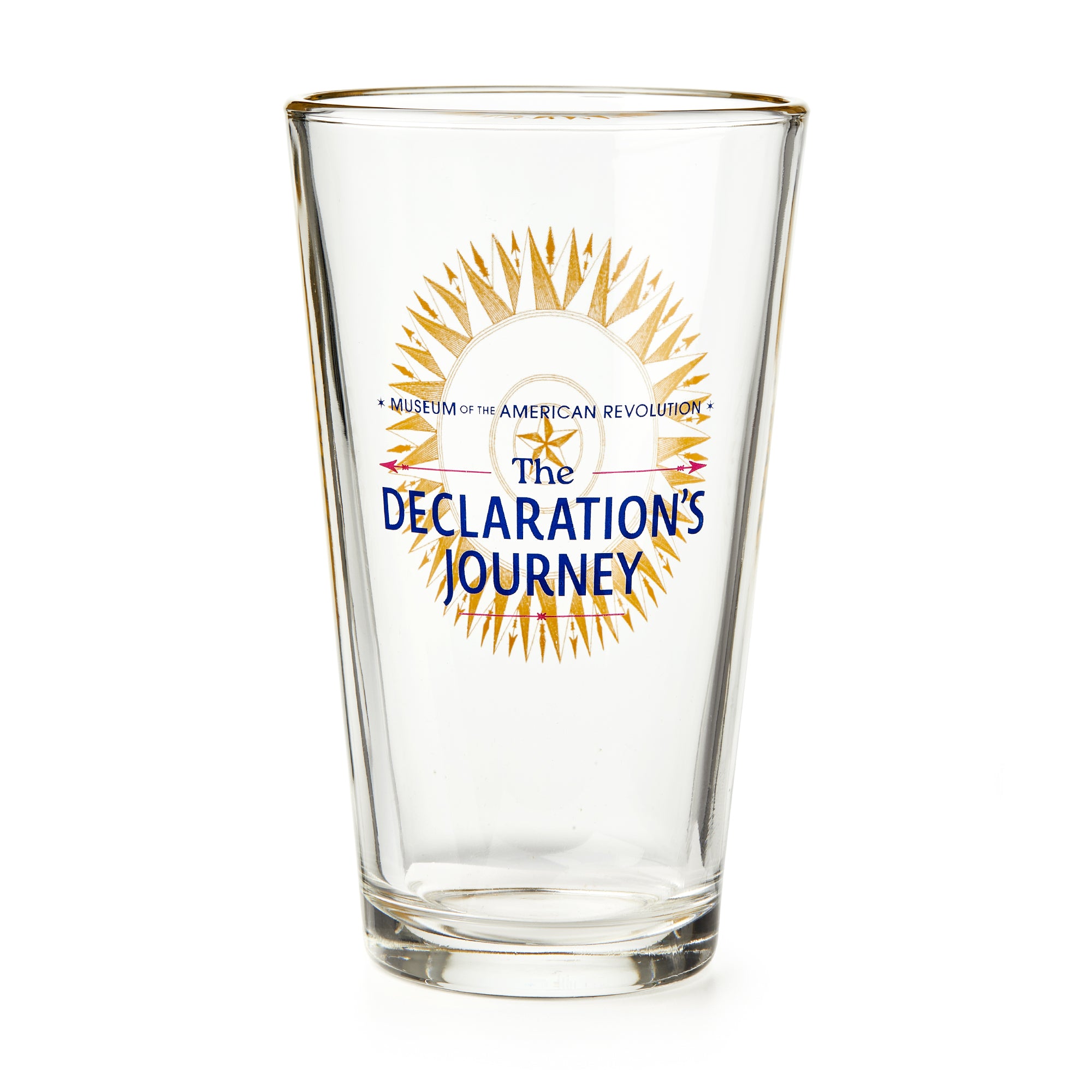 The Declaration's Journey Pint Glass is a clear glass pint with a gold rim, featuring the Museum of the American Revolution logo and “The Declaration’s Journey” in blue and gold on the front, celebrating the Semiquicentennial exhibition.