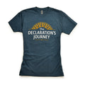 The Declaration's Journey T-Shirt features white "The Declaration’s Journey" text below a yellow sunburst on blue, displayed flat on white—ideal for commemorating the Declaration of Independence Semiquicentennial exhibition.
