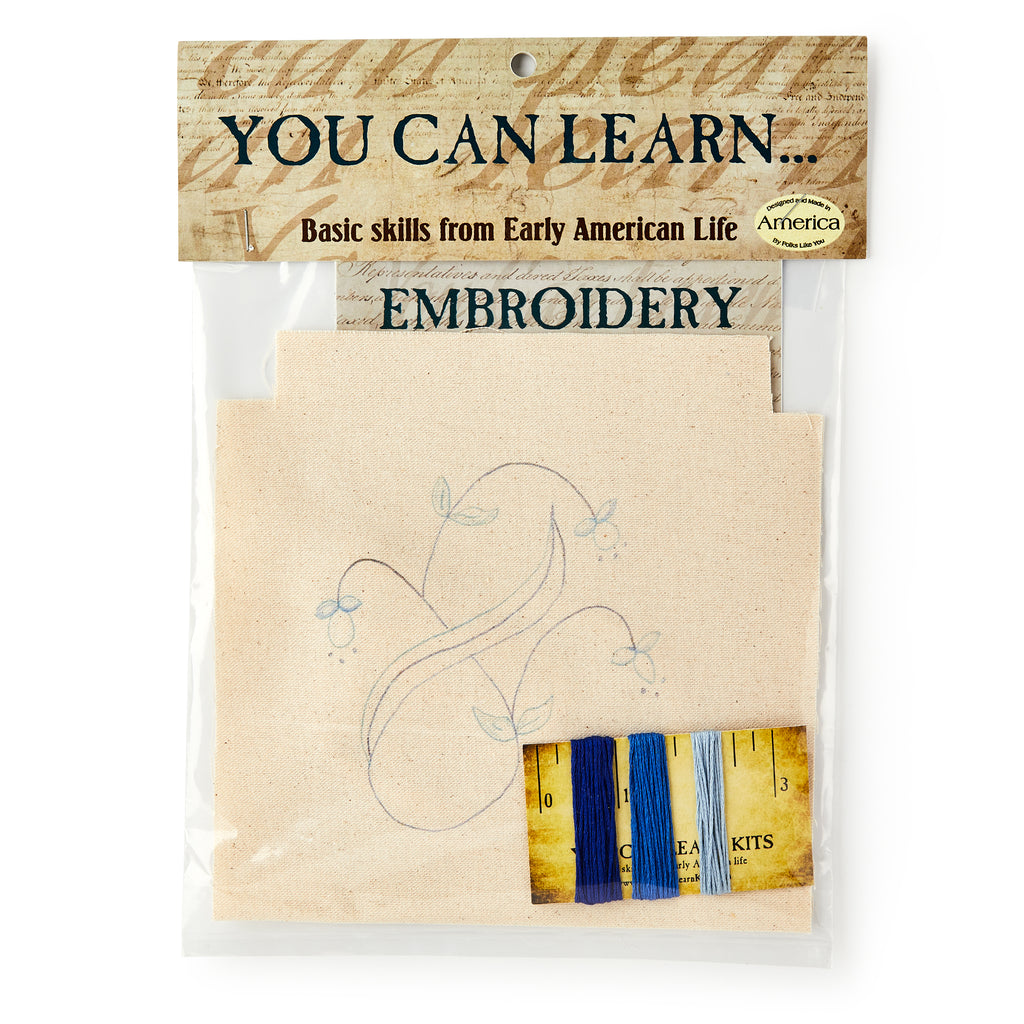 The Embroidery Kit comes in a plastic bag labeled "You Can Learn... Basic skills from Early American Life" and includes fabric with a floral outline plus four thread colors—ideal for beginners creating their first hand-stitched designs.