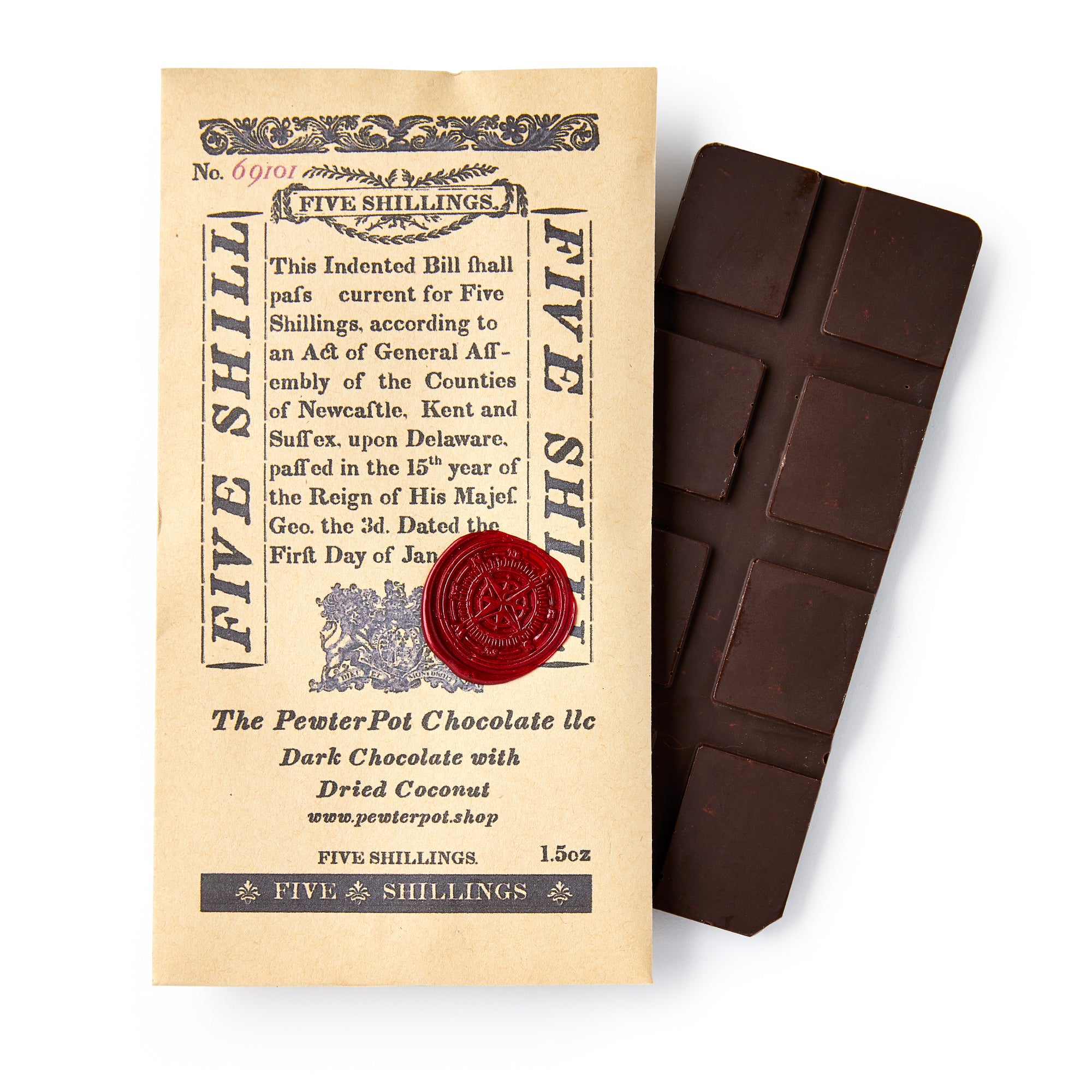 The Delaware Chocolate Bar, featuring visible squares, sits on vintage-style paper packaging labeled "FIVE SHILLINGS" and sealed with red wax, capturing the colonial heritage reflected in its ornate design and historical references.