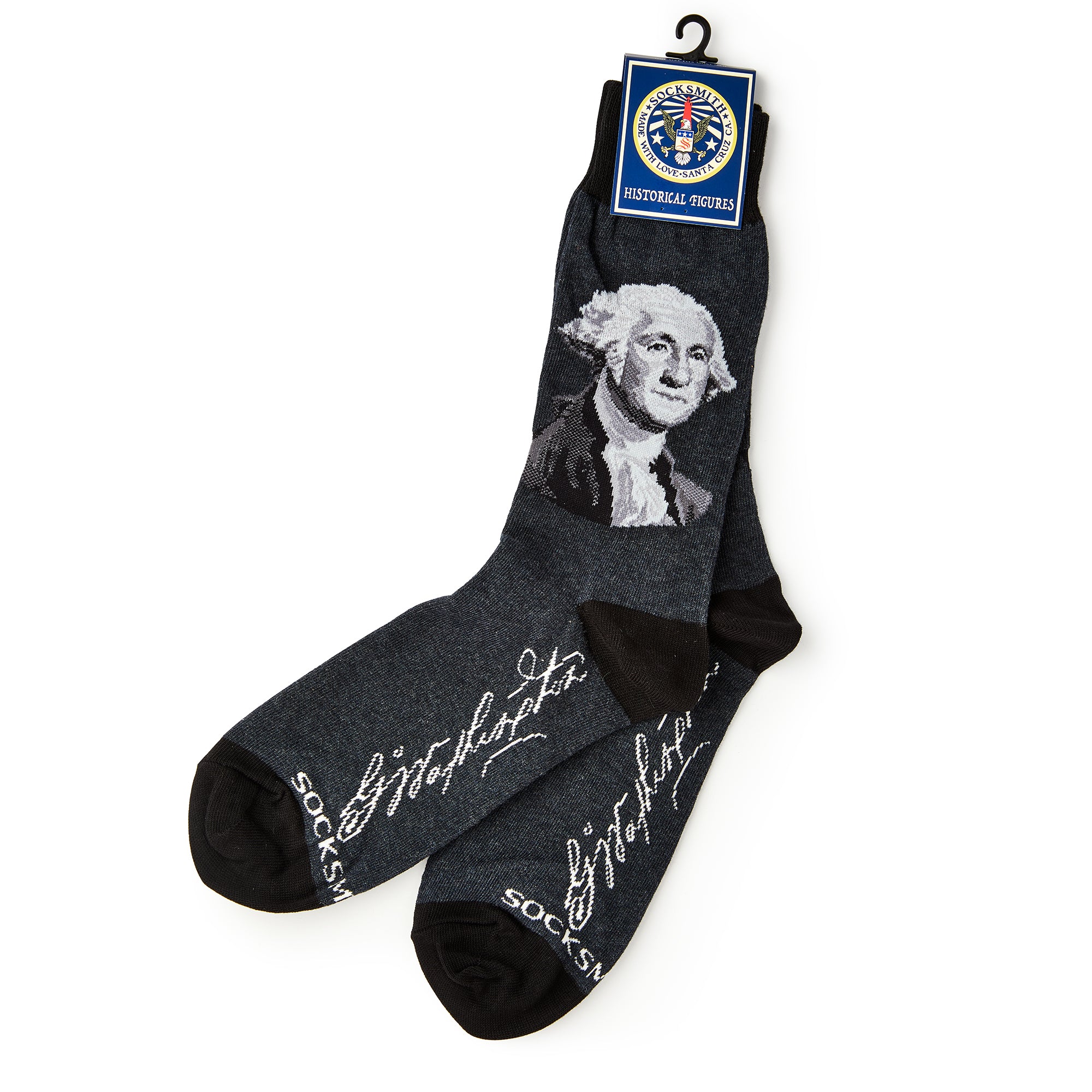 George Washington Socks featuring his portrait and white script signature, displayed with a tag labeled “Historical Voices.”.