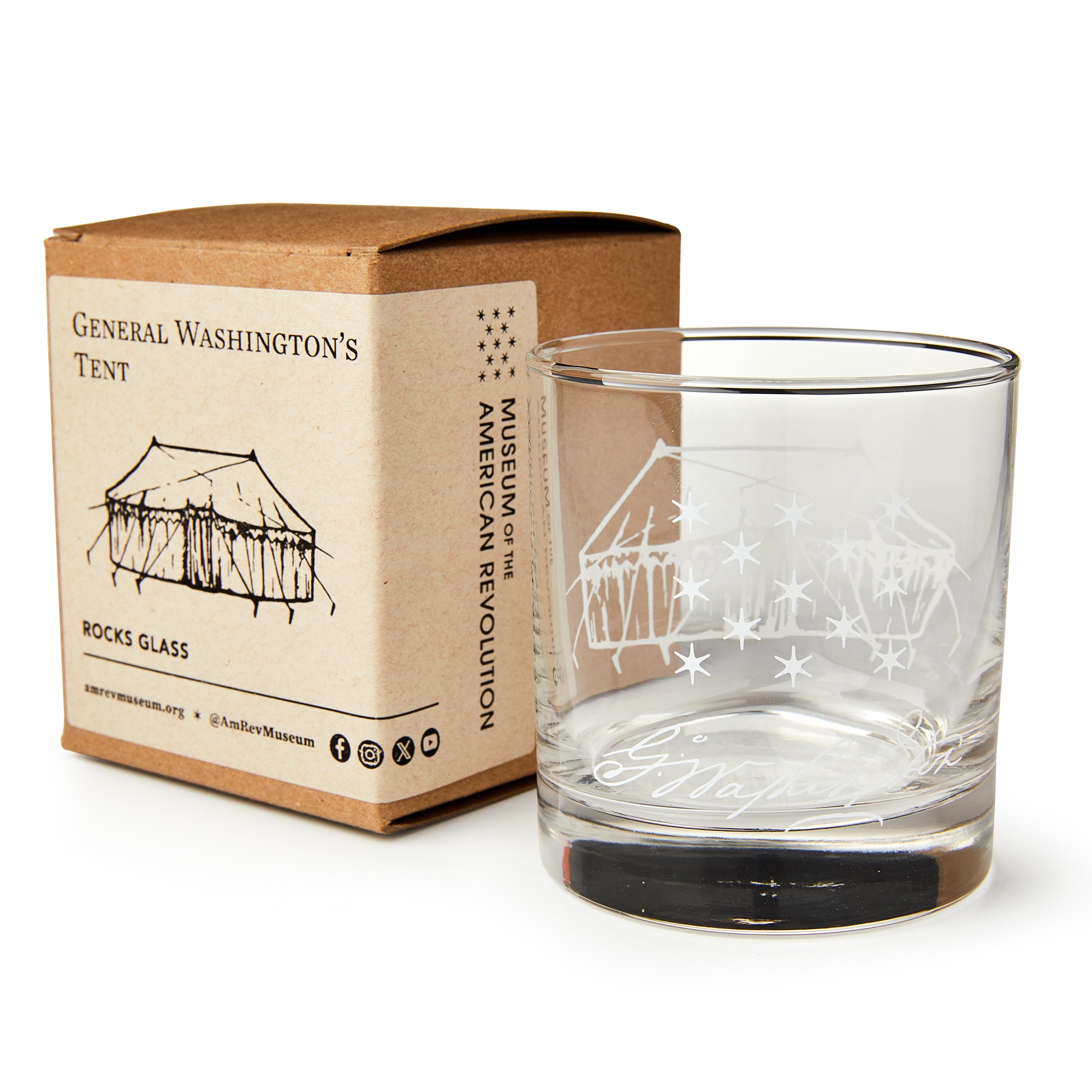 A George Washington Tent Whiskey Glass with an etched tent and stars sits beside a box labeled "General Washington's Tent" from the Museum of the American Revolution.