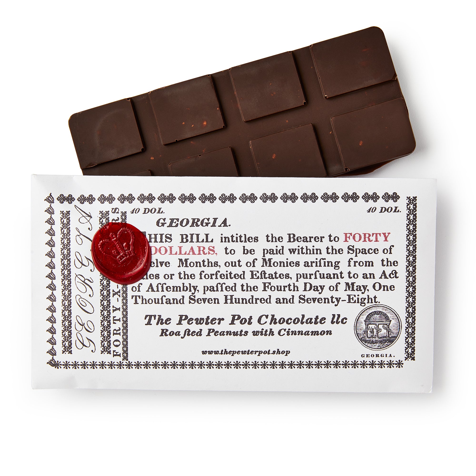 The Georgia Chocolate Bar is milk chocolate with roasted pecans and cinnamon, wrapped in white packaging styled like a vintage Georgia bill, featuring decorative text, a red wax seal, and "Forty Dollars" as a nod to American heritage.