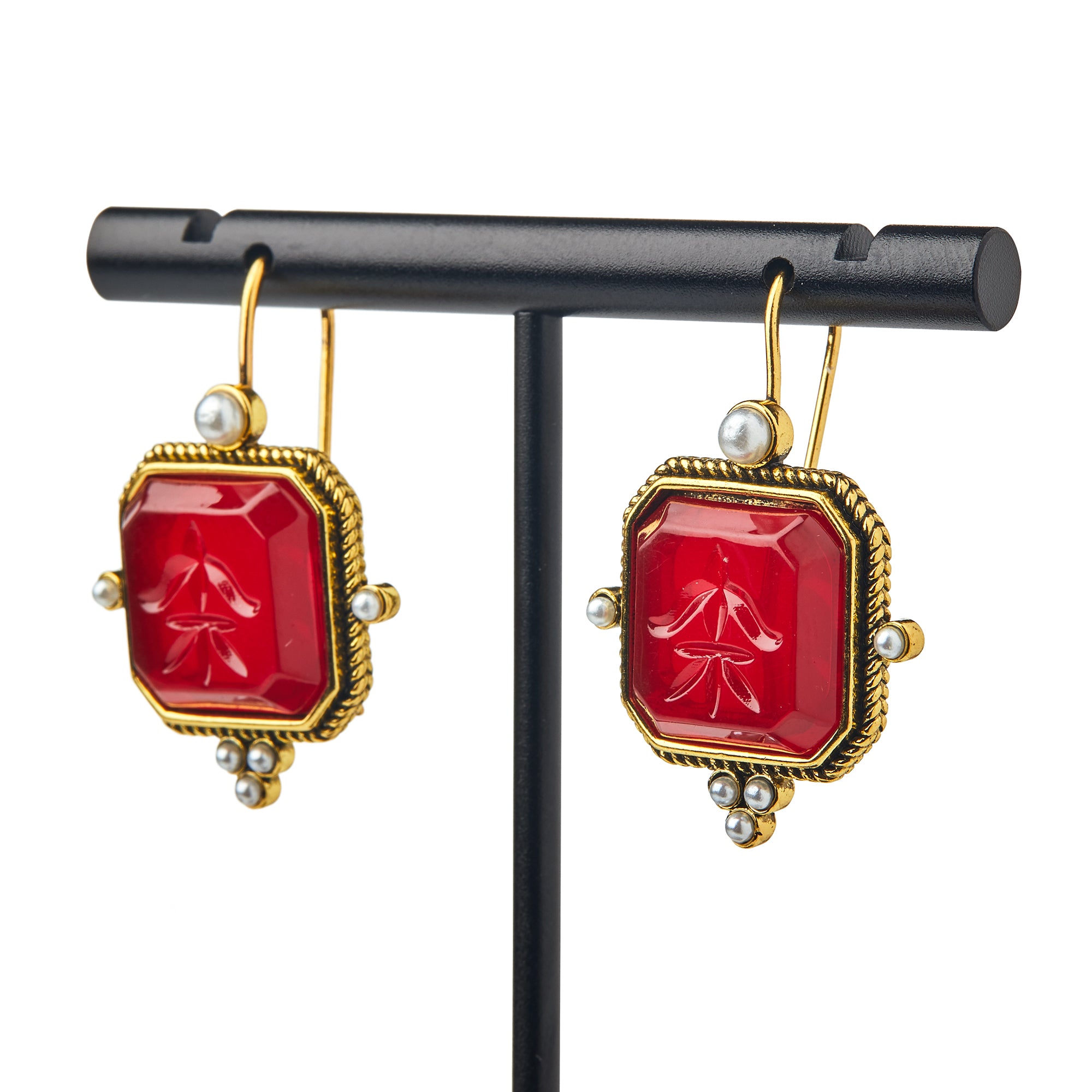 Glass Intaglio and Pearl Earrings, Garnet—rectangular garnet glass intaglios with pearl accents on gold-plated earwires—are shown on a black stand against a white background.