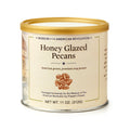 An 11 oz. round can of Honey Glazed Pecans with a gold lid, labeled for the Museum of the American Revolution and featuring an illustration of pecans; made from American-grown pecans.