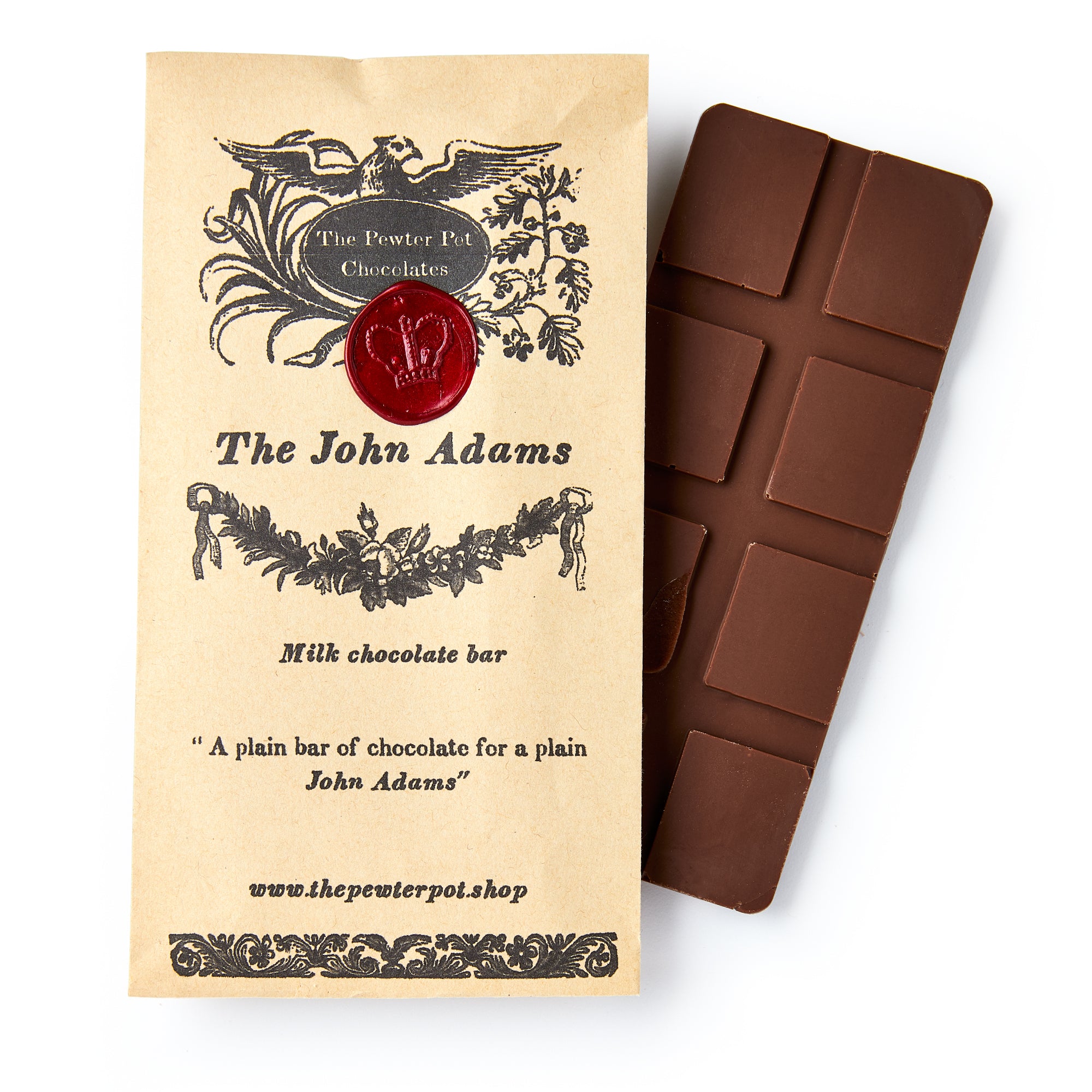 A partially unwrapped milk chocolate bar in vintage-style paper packaging labeled "John Adams Chocolate Bar," featuring a red wax seal and decorative black artwork for a charming, historical touch.