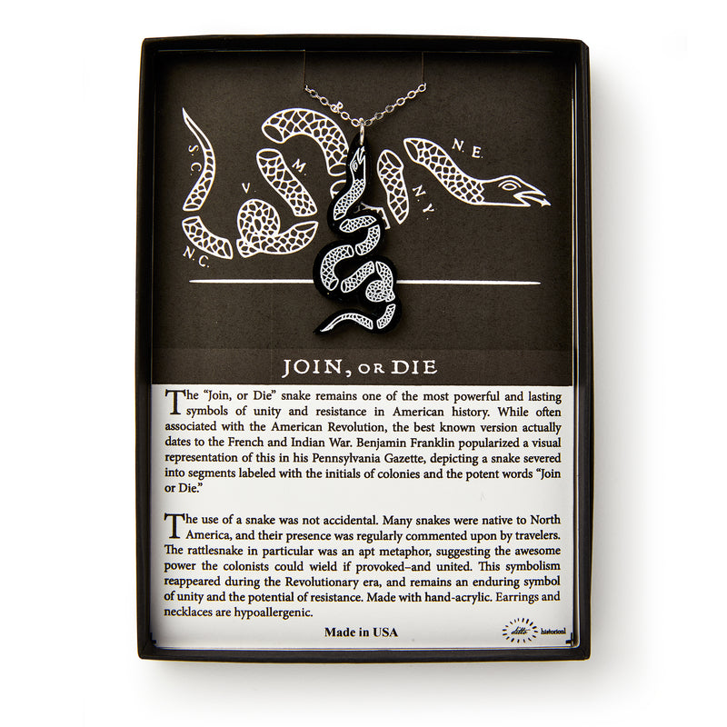 The Black Snake Necklace features a black and white snake pendant on a chain, presented in a box. The background shows the iconic Join or Die snake illustration with text explaining its Revolutionary-era jewelry significance.