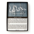 Clear Snake Earrings, Silver Wire are shaped like a segmented snake and displayed on a card with the Revolutionary era design. The card explains the symbol's history and notes the earrings are nickel-free and hypoallergenic.