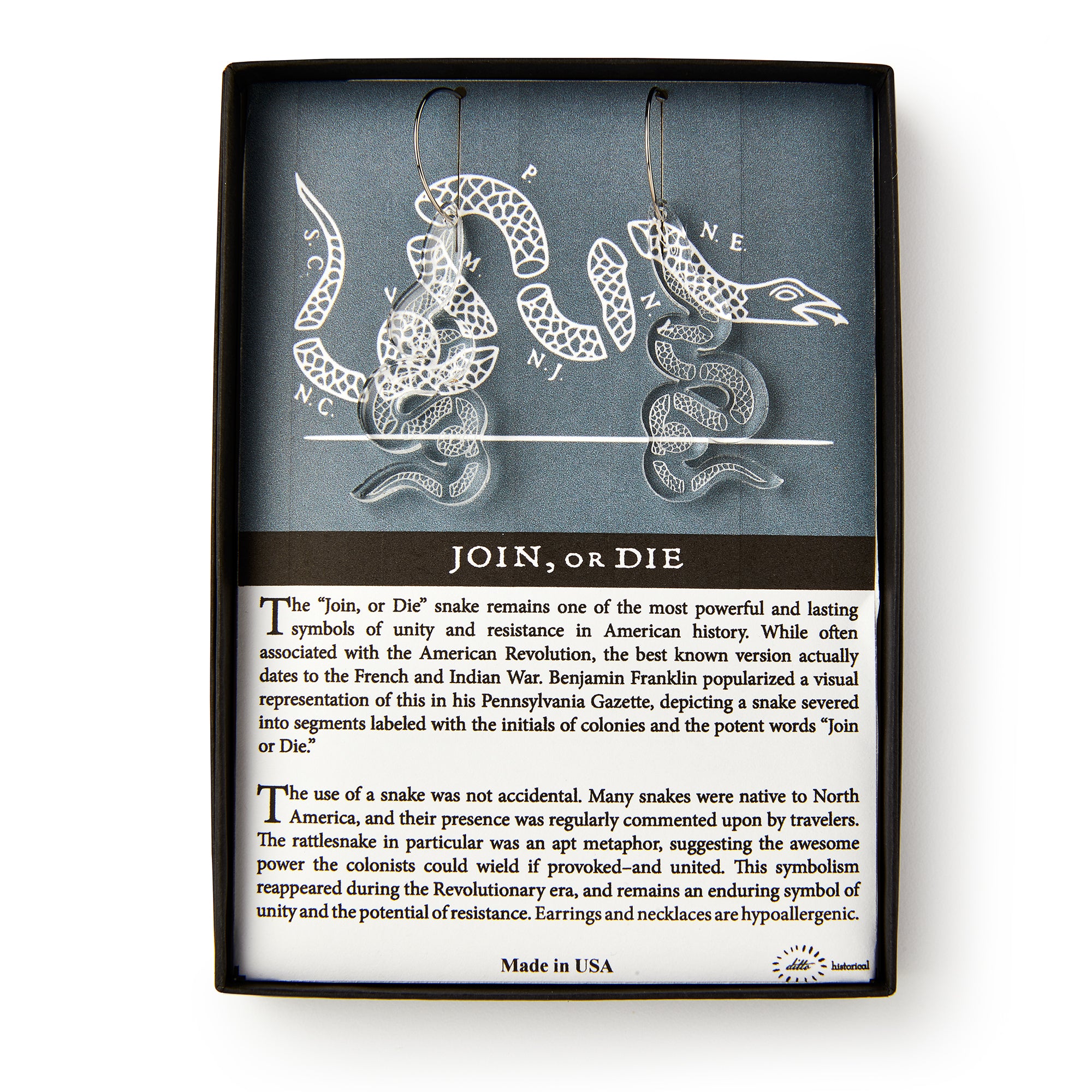 Clear Snake Earrings, Silver Wire are shaped like a segmented snake and displayed on a card with the Revolutionary era design. The card explains the symbol's history and notes the earrings are nickel-free and hypoallergenic.