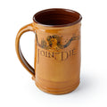The Join or Die Tankard is a handmade brown ceramic mug featuring a segmented snake with abbreviations and the words "Join or Die" below, symbolizing colonial unity.