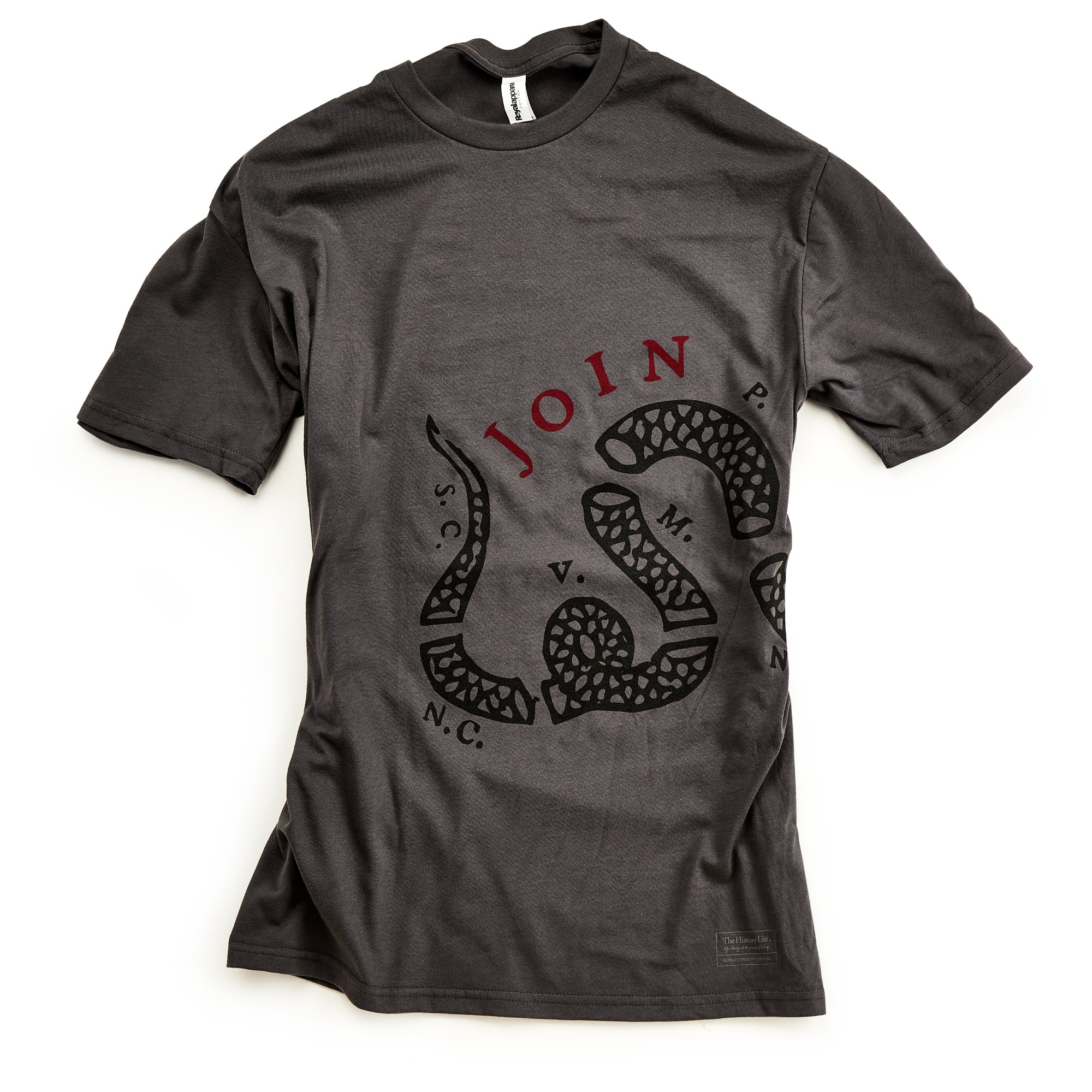 The Join or Die Crewneck T-Shirt is a dark gray tee featuring a coiled snake graphic inspired by Benjamin Franklin’s iconic illustration, with JOIN in red above and black initials such as N.C., S.C., P., and V. surrounding the snake on the front—ideal for fans of American Revolution-themed shirts.