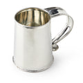 The Tavern Mug is a shiny, silver handcrafted tin mug with a large curved handle and a simple, smooth design. Photographed empty against a white background.