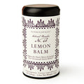 A cylindrical tin labeled "Lemon Balm Tea," decorated with purple designs, holds 20 citrus-flavored herbal tea bags for stress relief.
