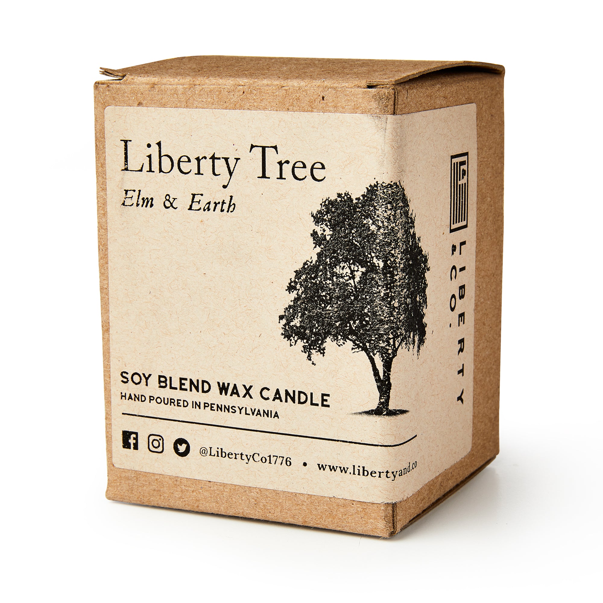 A brown cardboard box labeled Liberty Tree Candle features a black tree illustration and social media info, highlighting the hand-poured elm and earth soy blend scent made in Pennsylvania.