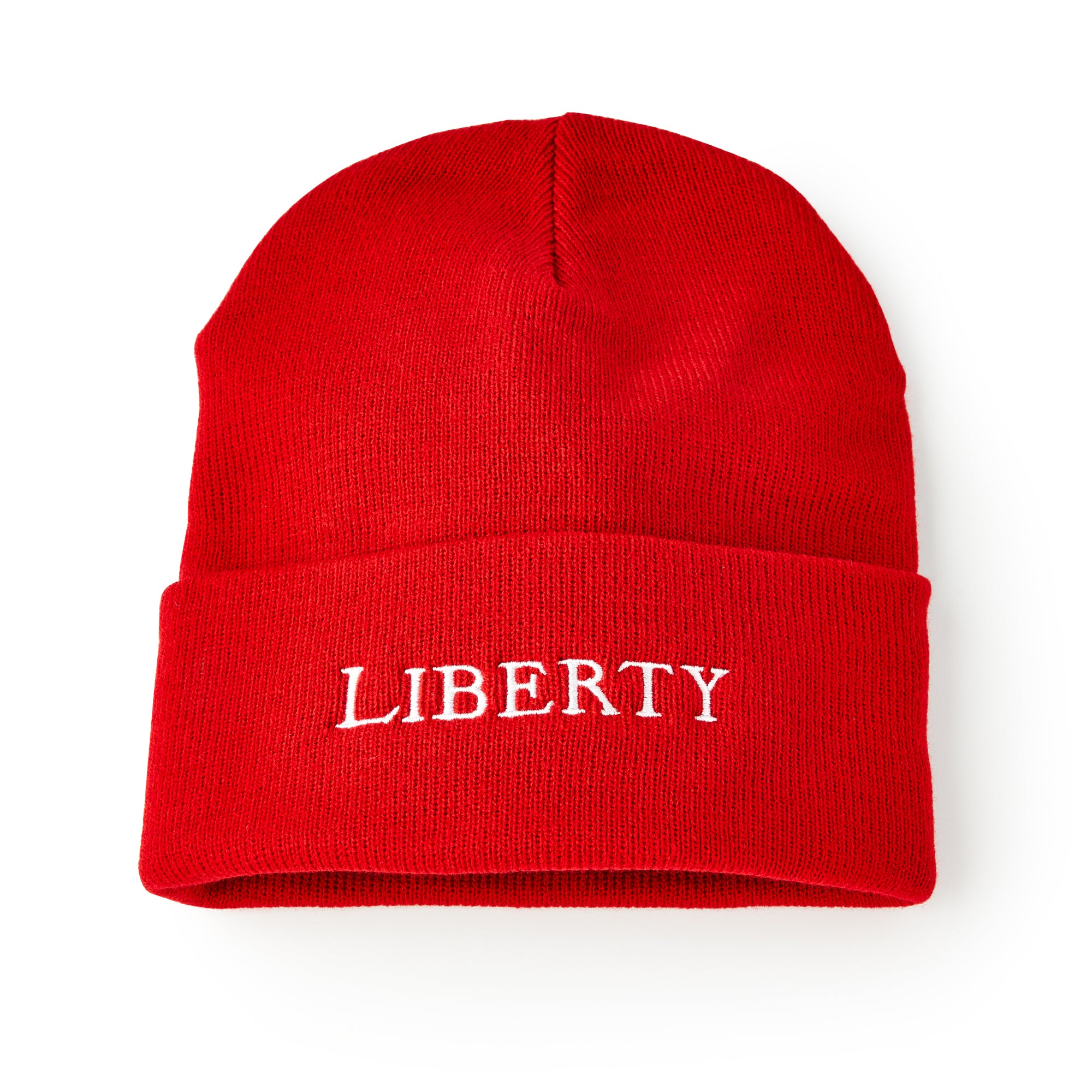 A bright red Liberty Cap Beanie, featuring "LIBERTY" embroidered in bold white letters on the front fold, combines American freedom and modern comfort, shown against a white background.