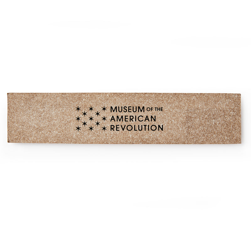 A rectangular bookmark engraved with the Museum of the American Revolution logo and name, featuring thirteen stars in a circular pattern above the text. 