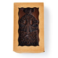 Wooden stamp with decorative design in craft paper packaging.