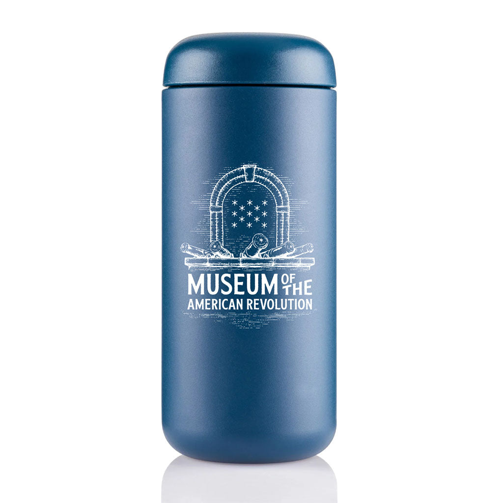 A blue stainless steel Museum Travel Mug featuring a white illustration of a doorway with cannons and stars on the front.