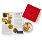 A red box labeled 1789, an open booklet on Washington Presidential Inaugural Buttons with images, and the Memorable Era Paperweight featuring an eagle are displayed in a clear case.
