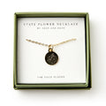 The Mountain Laurel Necklace features a gold-plated, floral-engraved round pendant in a green box labeled "State Flower Necklace," celebrating Pennsylvania's state flower and botanical artistry.
