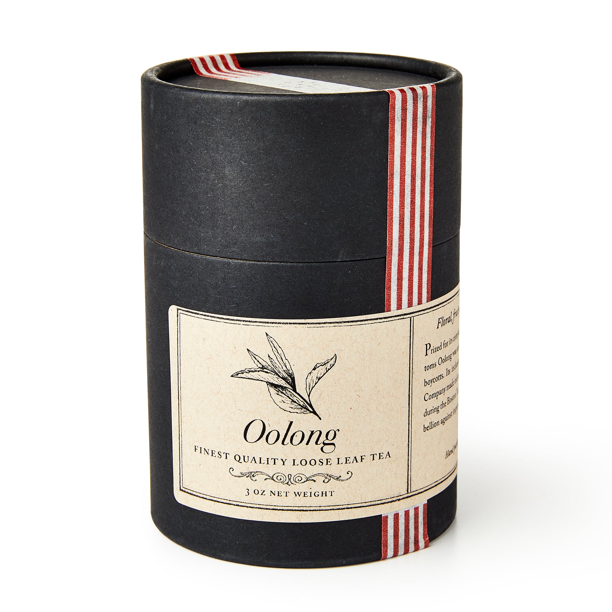 A black cylindrical container of Oolong Loose Leaf Tea features a beige label with a tea leaf illustration and is wrapped with a red-striped ribbon.