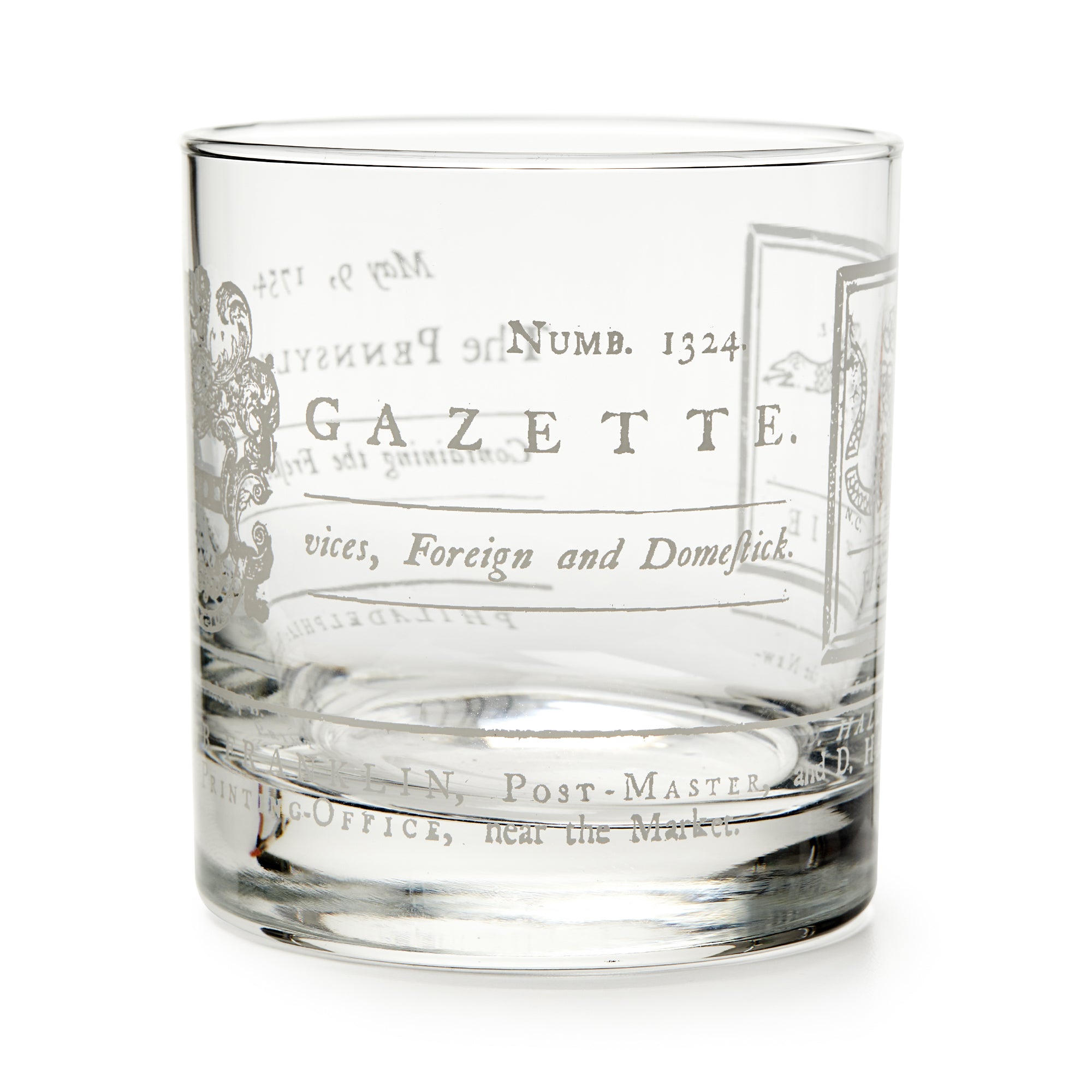 The Join or Die Whiskey Glass is a clear tumbler inspired by American history, featuring vintage-style printed text, decorative flourishes, old-fashioned fonts and numbers—evoking Benjamin Franklin’s era.
