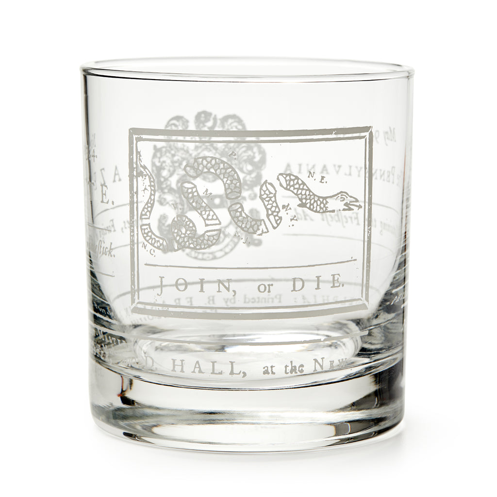 The Join or Die Whiskey Glass features an etched segmented snake and the words JOIN, or DIE beneath it, inspired by Benjamin Franklin's iconic American history design.