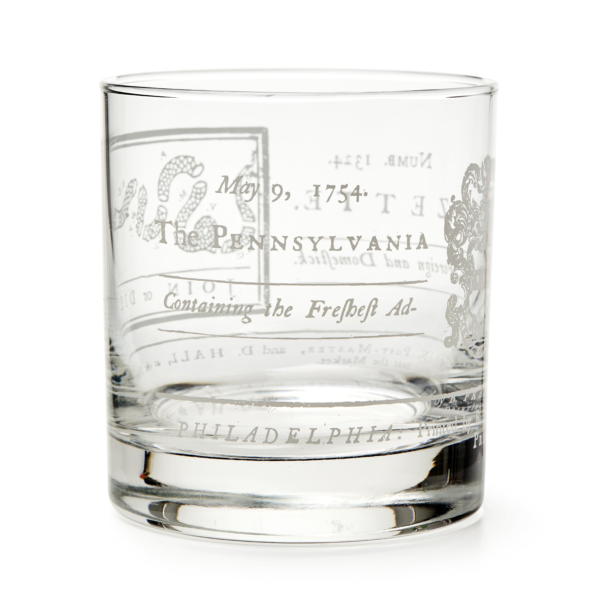 The Join or Die Whiskey Glass is a clear tumbler engraved with "May 9, 1754," Pennsylvania, and vintage motifs inspired by Benjamin Franklin’s iconic design—a unique tribute to American history.