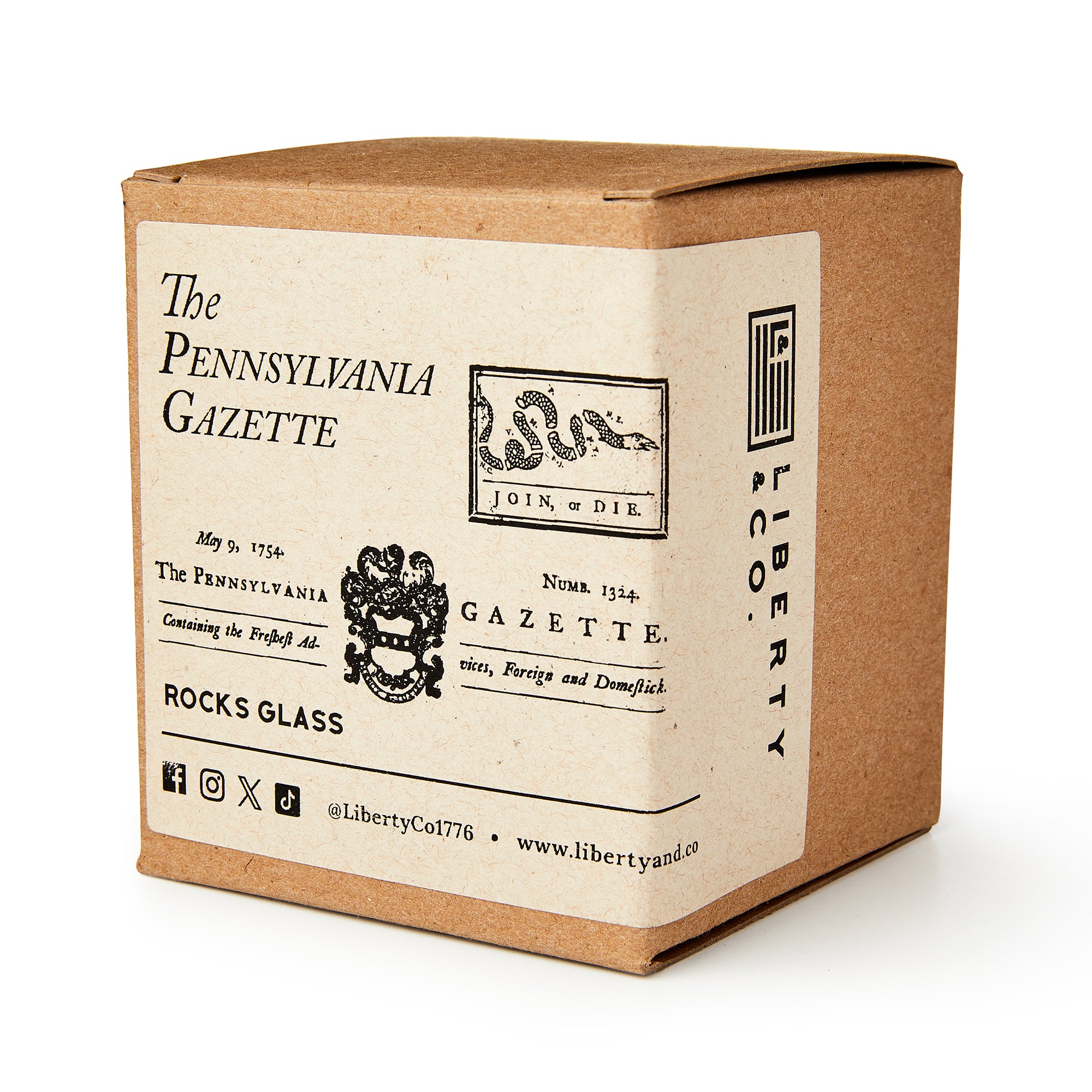 A brown cardboard box labeled "Join or Die Whiskey Glass" features vintage text, a historic snake graphic, and web/social media icons—evoking American history and Benjamin Franklin.