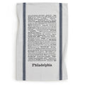 The Philadelphia Tea Towel features black typographic trivia about the city's landmarks, sports teams, foods, and neighborhoods. Handprinted with two vertical dark stripes on each side.