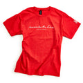 The Remember the Ladies T-Shirt, Youth, is a red tee with white cursive text on the chest reading "heaven but the ladies and Adrienne Rich," honoring women's rights. It also features a small white design on the left sleeve.