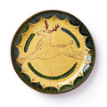 The Deer Plate is a handcrafted ceramic piece with a yellow background, leaping deer with red antlers and brown spots, green leaf border accents, and two curved branches beneath for classic folk pottery charm.