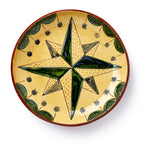 The Star Plate is a decorative sgraffito piece inspired by Pennsylvania German pottery, with a green and yellow central star, black stars, and leaf motifs on a yellow background.