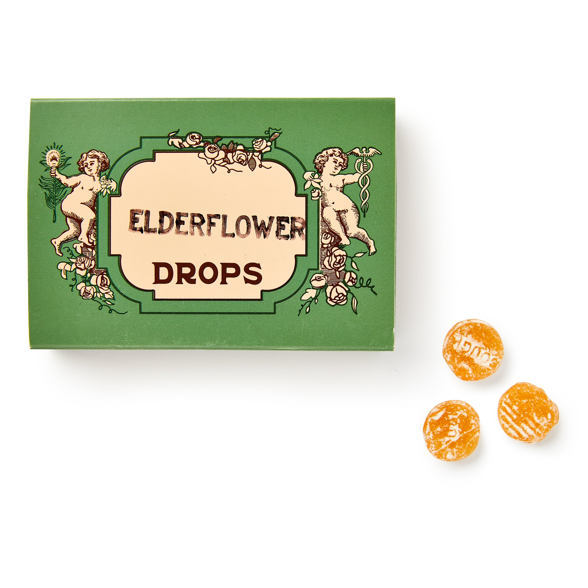 A green box of Elderflower Drops sits beside three yellow cough drops on a white background.