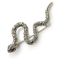 The Silver Crystal Snake Brooch features silver plating, sparkling rhinestones in pave detailing along its coiled body, and intricately crafted head and tail.