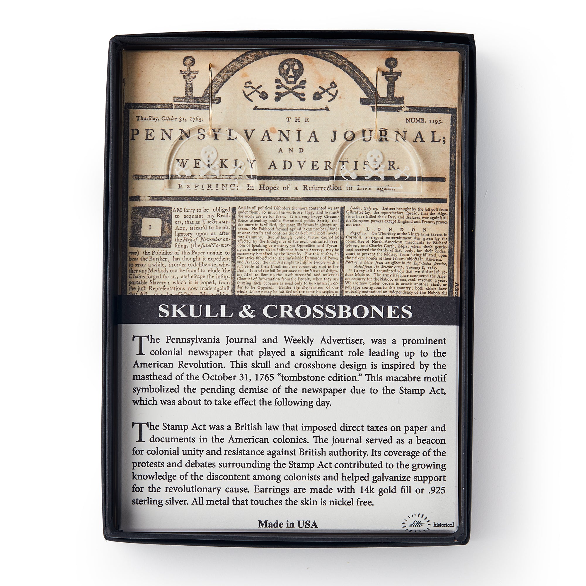A display box features The Pennsylvania Journal with a skull and crossbones, echoed in nearby Skull and Crossbone Earrings, plus an info card explaining the newspaper’s impact during the American Revolution.