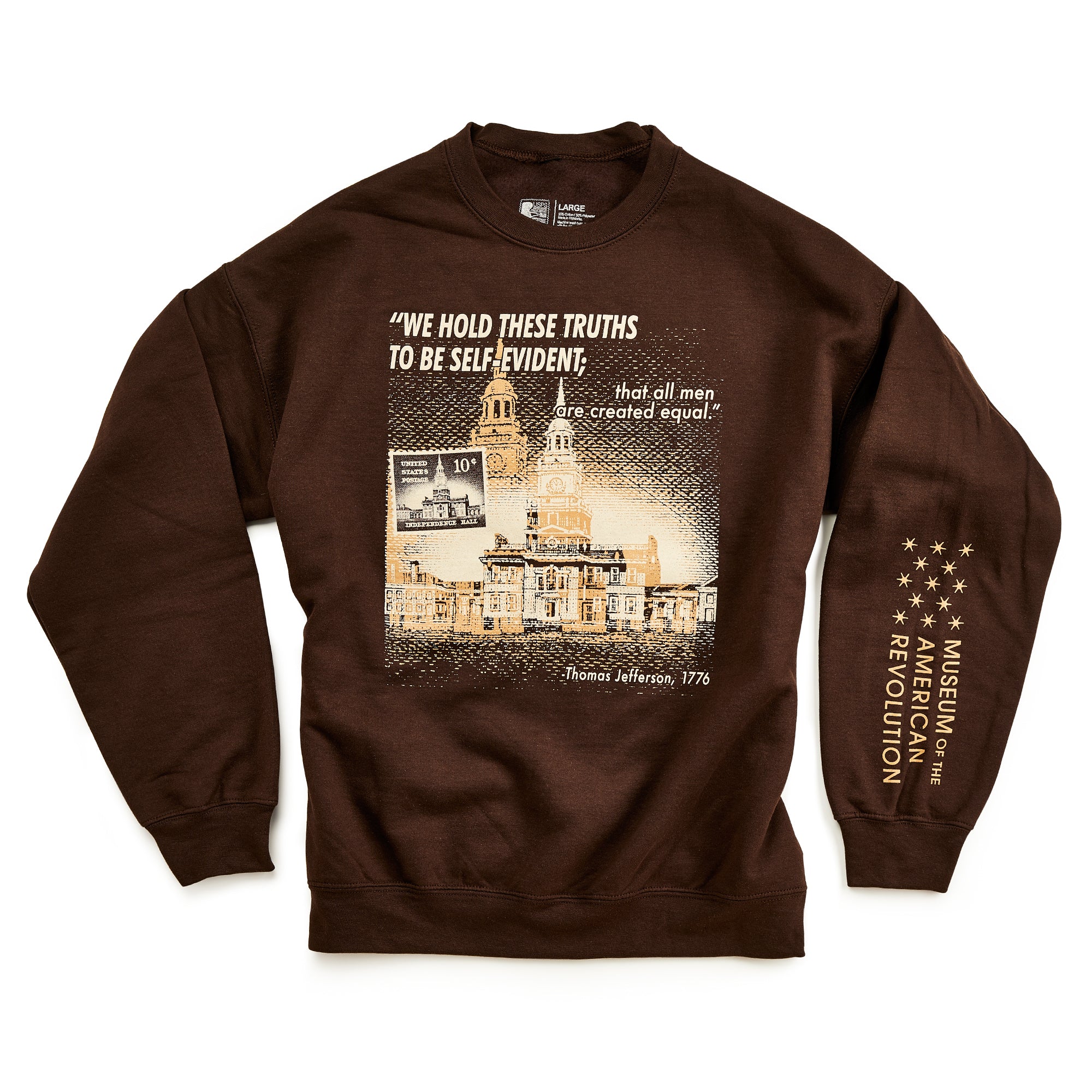 The Thomas Jefferson Sweatshirt in brown features Independence Hall, a 10¢ stamp, his iconic quote, and the Museum of the American Revolution logo on the sleeve—a stylish tribute to the Founding Fathers.