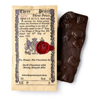 Dark chocolate bar with honey biscuit bits next to a vintage-style packaging label.