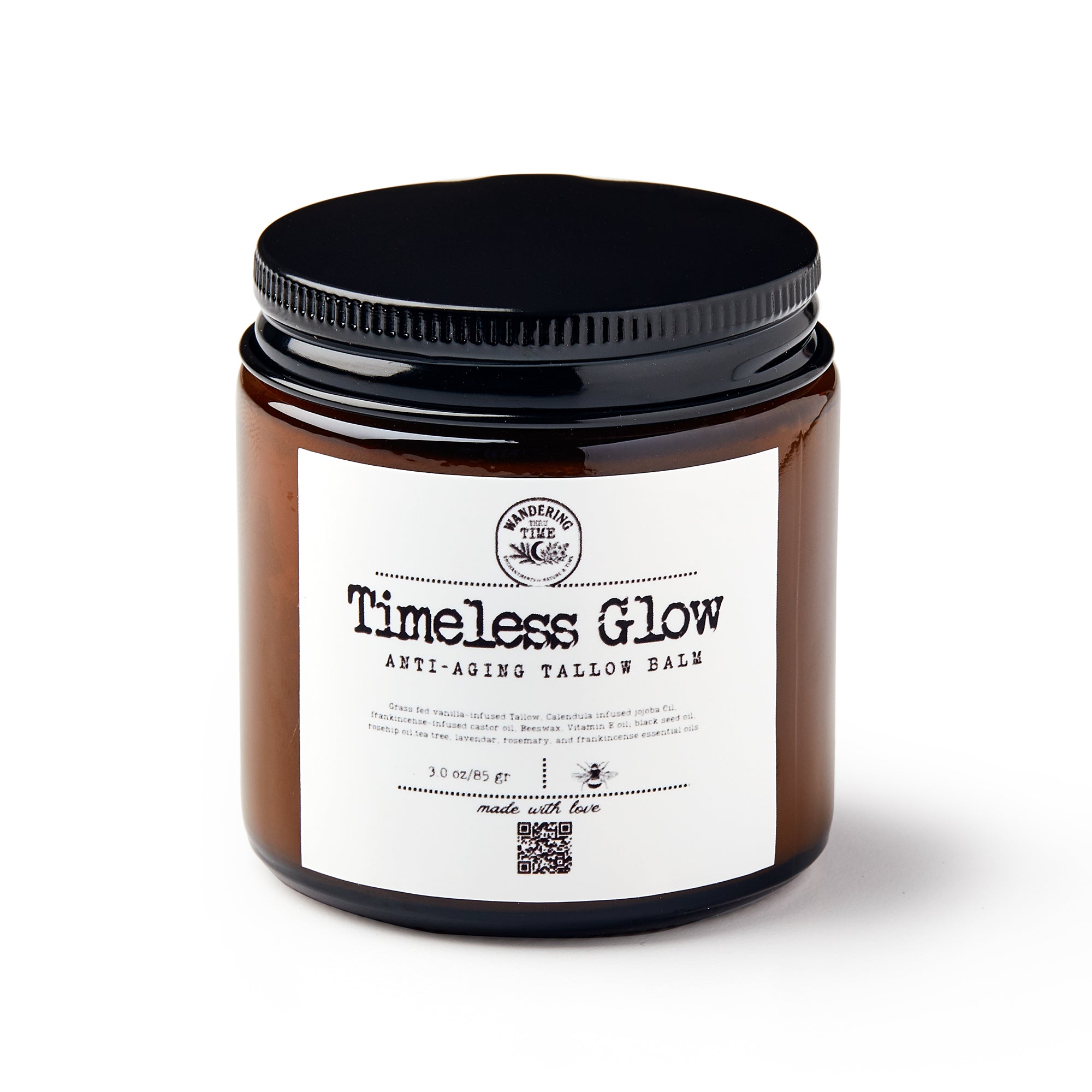 A brown glass jar with a black lid labeled Timeless Glow Balm. The white label lists natural ingredients, product details, weight (3 oz/85 g), and features a QR code at the bottom.