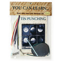 The Tin Punching Kit includes colored wires, metal pieces, a small hammer, and an instruction booklet so you can create beautiful punched tin designs—packaged under the label "You Can Learn... Basic skills from Early American Life.