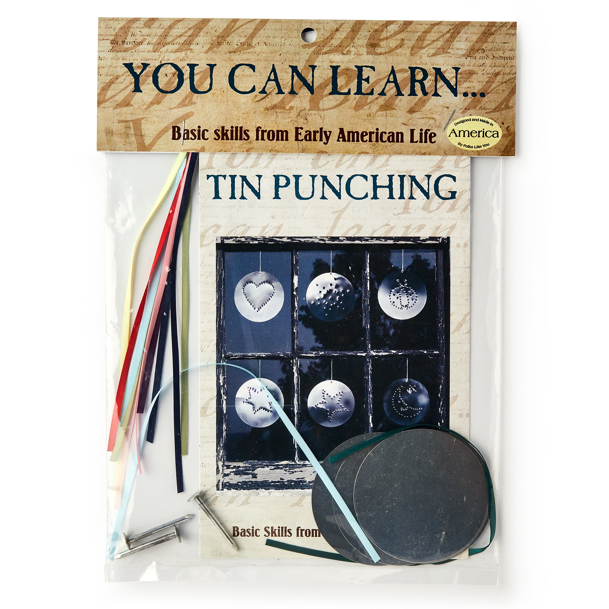 The Tin Punching Kit includes colored wires, metal pieces, a small hammer, and an instruction booklet so you can create beautiful punched tin designs—packaged under the label "You Can Learn... Basic skills from Early American Life.