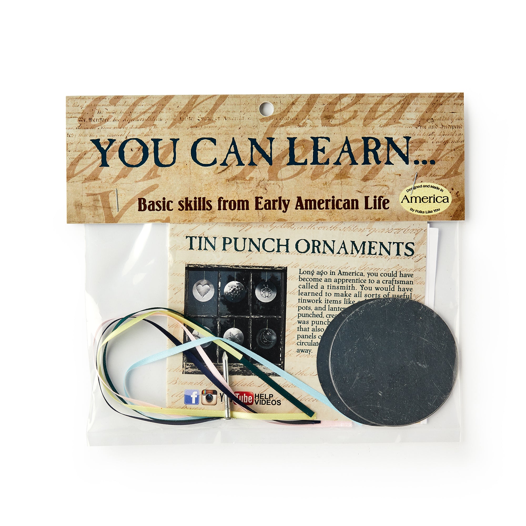 The Tin Ornament Kit includes metal circles, a ribbon, and an instruction card for making tin ornaments. Packaged in a clear plastic pouch, it's labeled "You Can Learn... Basic skills" from Early American Life.