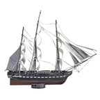Model of a three-masted sailing ship on a white background